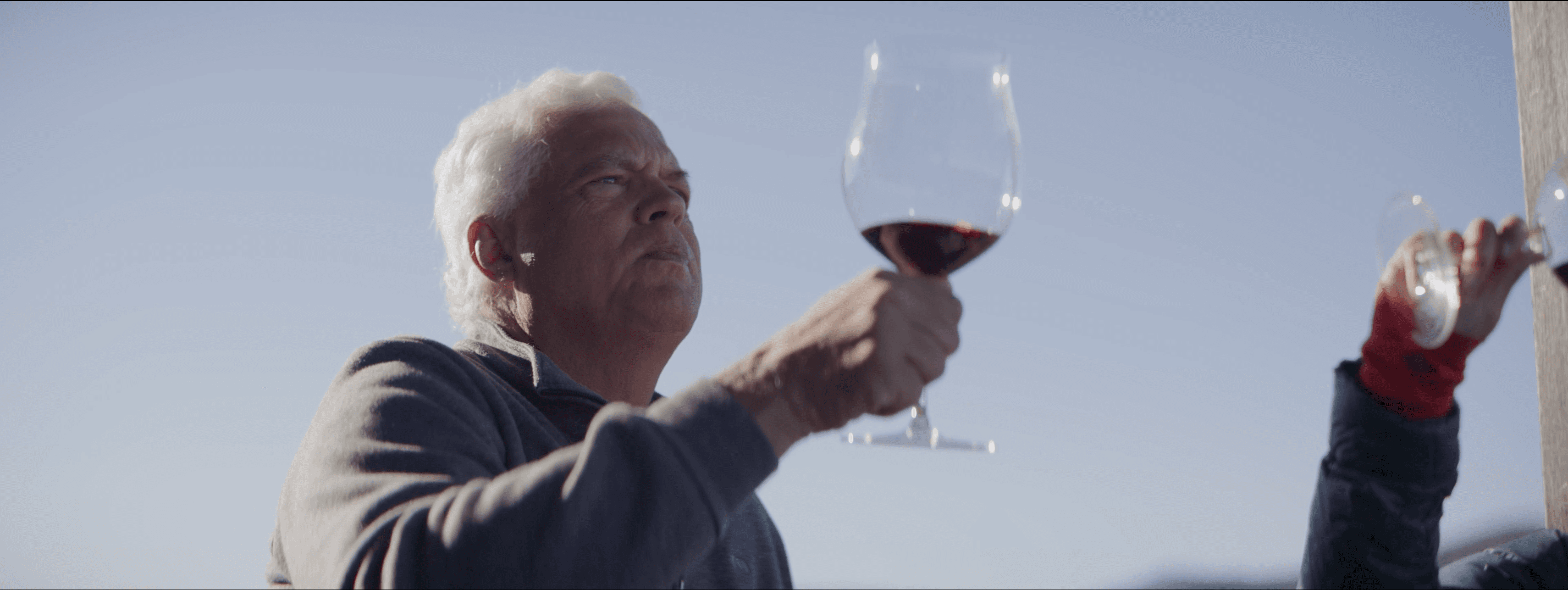 Andy Paul examining a glass of red wine